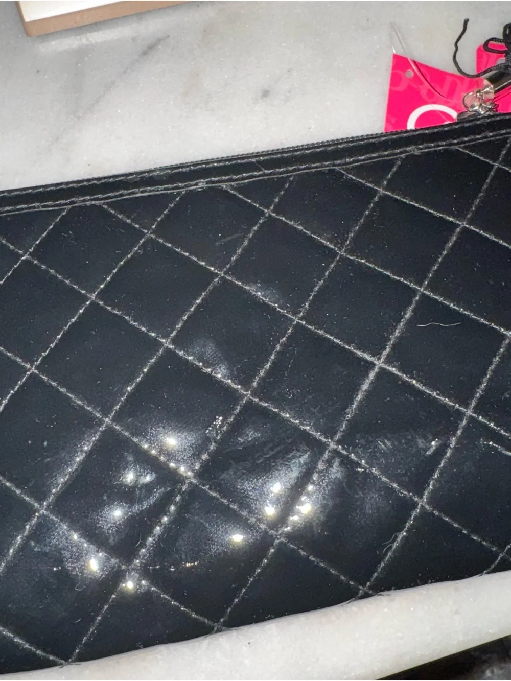 Shiny black quilted cosmetics bag